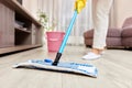 young woman mopping floor at living room Royalty Free Stock Photo