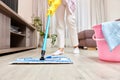 young woman mopping floor at living room Royalty Free Stock Photo
