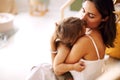 Young woman mother expressing love to little baby,mom kissing sleeping child in hands Royalty Free Stock Photo