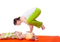 Young woman mother practicing yoga with baby