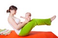 Young woman mother practicing yoga with baby