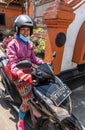 Young woman on motorbike in Dusun Ambengan, Bali Indonesia