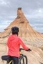 Young woman mountain bike cyclist next to Castildetierra Mountain in Badlans of Navarre Bardenas Reales de Navarra dessert Royalty Free Stock Photo