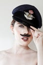 Young woman with moustache wearing cap