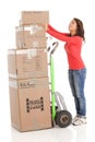 Young woman moving boxes with with a hand truck or dolly.