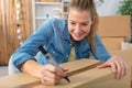 young woman moving into new apartment packing cardboard boxes Royalty Free Stock Photo