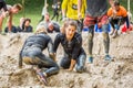 Young woman in mud obstacle. Royalty Free Stock Photo