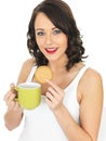 Young Woman with a Mug of Tea and Biscuit Royalty Free Stock Photo