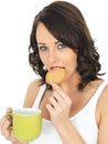 Young Woman with a Mug of Tea and Biscuit Royalty Free Stock Photo