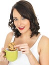 Young Woman with a Mug of Tea and Biscuit Royalty Free Stock Photo