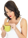 Young Woman with a Mug of Tea and Biscuit Royalty Free Stock Photo