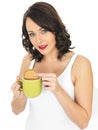 Young Woman with a Mug of Tea and Biscuit Royalty Free Stock Photo