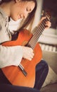 Young woman relaxing playing guitar at home Royalty Free Stock Photo