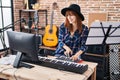 Young woman musician playing piano keyboard at music studio Royalty Free Stock Photo