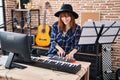 Young woman musician playing piano keyboard at music studio Royalty Free Stock Photo