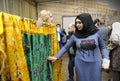 Young woman muslim touches Islamic shrine - the blanket from the tomb of Sheikh Abdul Qadir Jilani. Celebrating Islamic