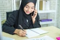 Young woman muslim work in office using phone Royalty Free Stock Photo