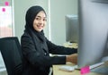 Young woman muslim work in office using phone