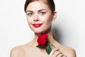 Young woman naked shoulders Clear skin smile red lips rose flower charm light Royalty Free Stock Photo