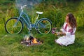 Young woman in national ukrainian folk costume with bicycle Royalty Free Stock Photo