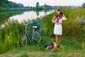 Young woman in national ukrainian folk costume with bicycle Royalty Free Stock Photo