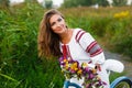 Young woman in national ukrainian folk costume with bicycle Royalty Free Stock Photo