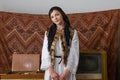 Young woman in national wjite dress and black handkerchief looking at the camera