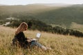 Young women with laptop and mask in the nature Royalty Free Stock Photo