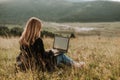 Young women with laptop in the nature, remote job Royalty Free Stock Photo