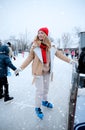 Young woman near fence at ice skating rink Royalty Free Stock Photo