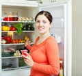 Young woman near fridge