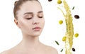 Young woman near splash of olive oil. Skincare concept. Royalty Free Stock Photo