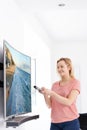 Young Woman With New Curved Screen Television At Home Royalty Free Stock Photo