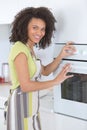 Young woman next to oven Royalty Free Stock Photo