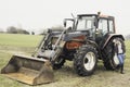 Young woman next to a tractor Royalty Free Stock Photo