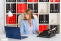 Young woman with notebook and typewriter. Royalty Free Stock Photo