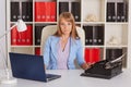 Young woman with notebook and typewriter. Royalty Free Stock Photo