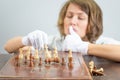 Young woman nurse doctor playing chess checkmate thinking game pieces. Royalty Free Stock Photo