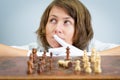 Young woman nurse doctor playing chess checkmate thinking game pieces. Royalty Free Stock Photo