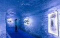 Young woman observes the photos inside of a blue ice cave in the French Alps. Royalty Free Stock Photo