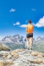 A young woman observes the view in the mountains