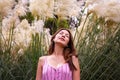 Young woman observing some wildflowers above her and surround in background