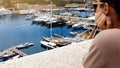 Young woman observing yachts in port, dreaming of oligarch and rich life Royalty Free Stock Photo