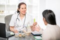 Young woman in an office at the doctor homeopaths. Royalty Free Stock Photo