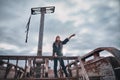 A young woman in old clothes stands on Board an old pirate ship. Girl the Corsair shows up where there is land Royalty Free Stock Photo