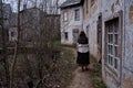 A young woman in an old fashioned headscarf of an quarantined from the virus in city Europe. A girl walks along an empty European