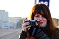 Young woman with old photocamera