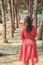 A young woman and old trees in an archaeological Park at the excavations of Carthage, Tunisia, Africa