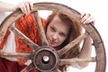 Young woman with an old wagon wheel Royalty Free Stock Photo