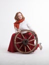 Young woman with an old wagon wheel Royalty Free Stock Photo